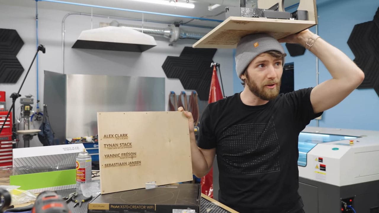 Linus holding the case panel with the designers’ names etched into it