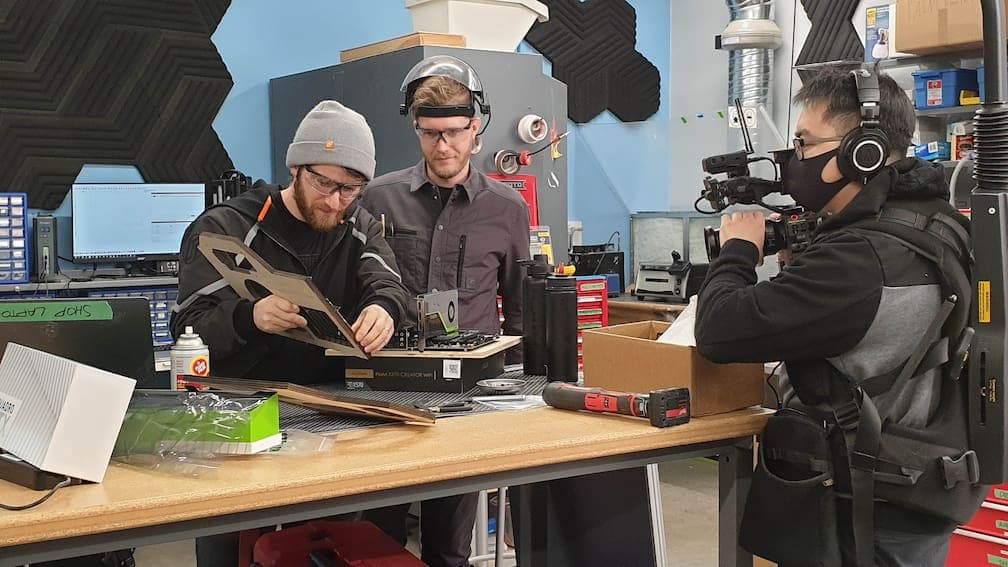 Linus and Alex working on the PC with a camera operator